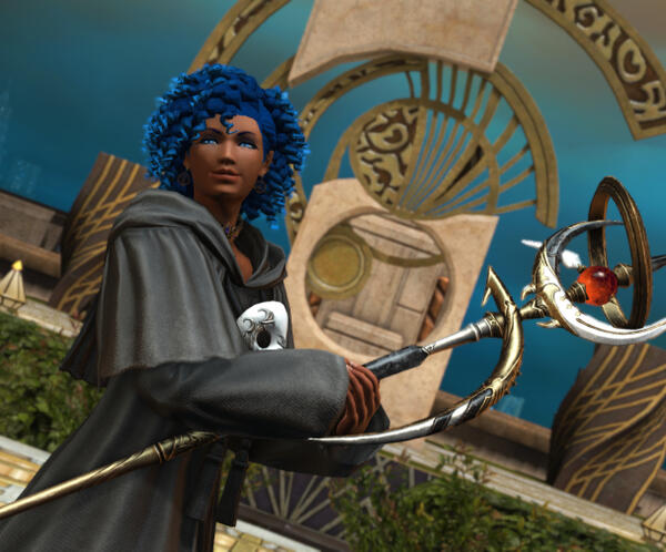 A smiling raen male Au'ra. He has black hair, pale skin, freckles, and is wearing the heirloom top of casting in black with round glasses.